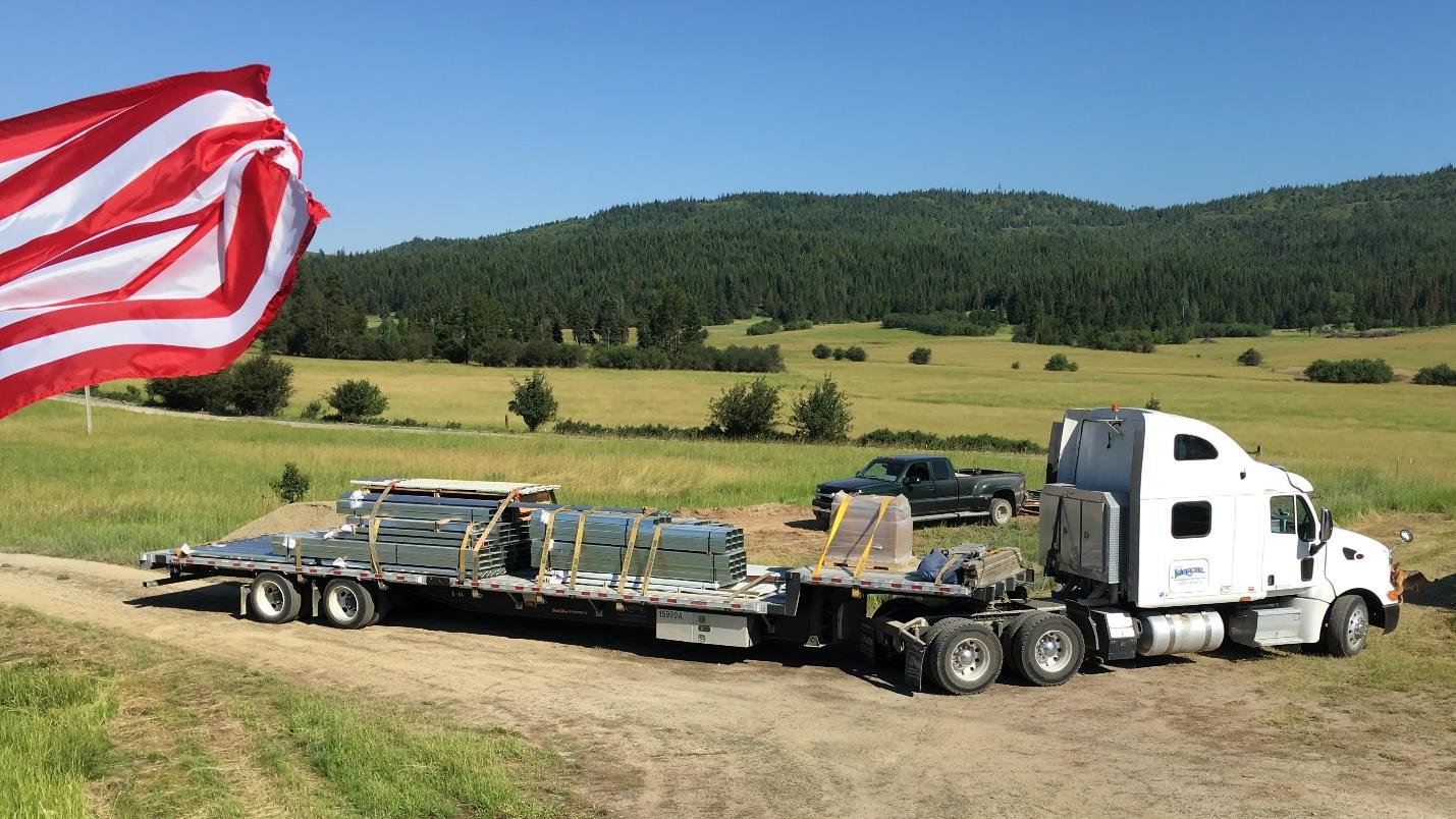 Flatbed truck delivering a steel building kit